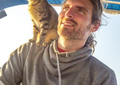Kitten on man's shoulder while sailing in Lefkada, Greece